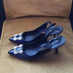 Black patent leather sling back pumps